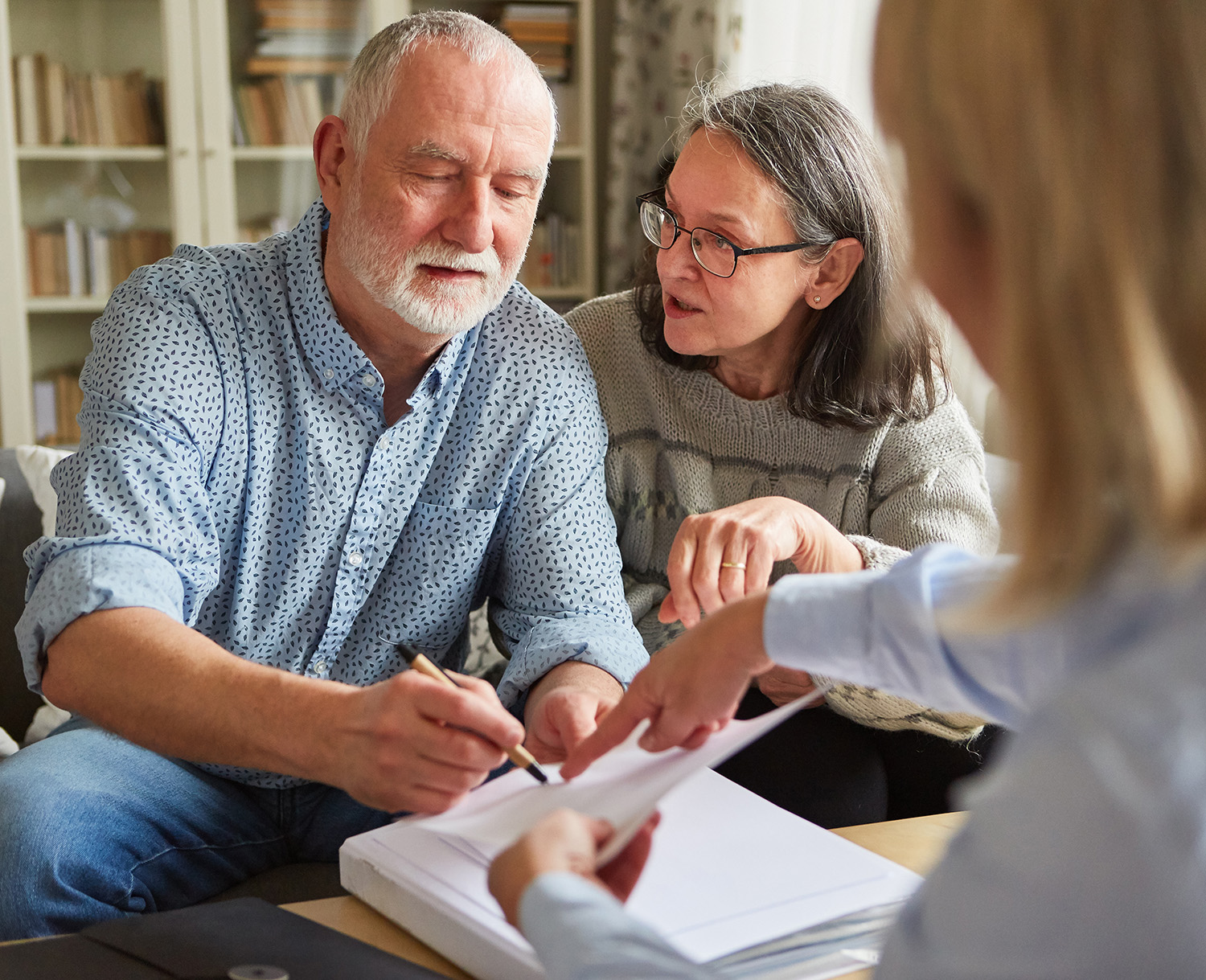 Older couple discussing plans with a health care advocate. 