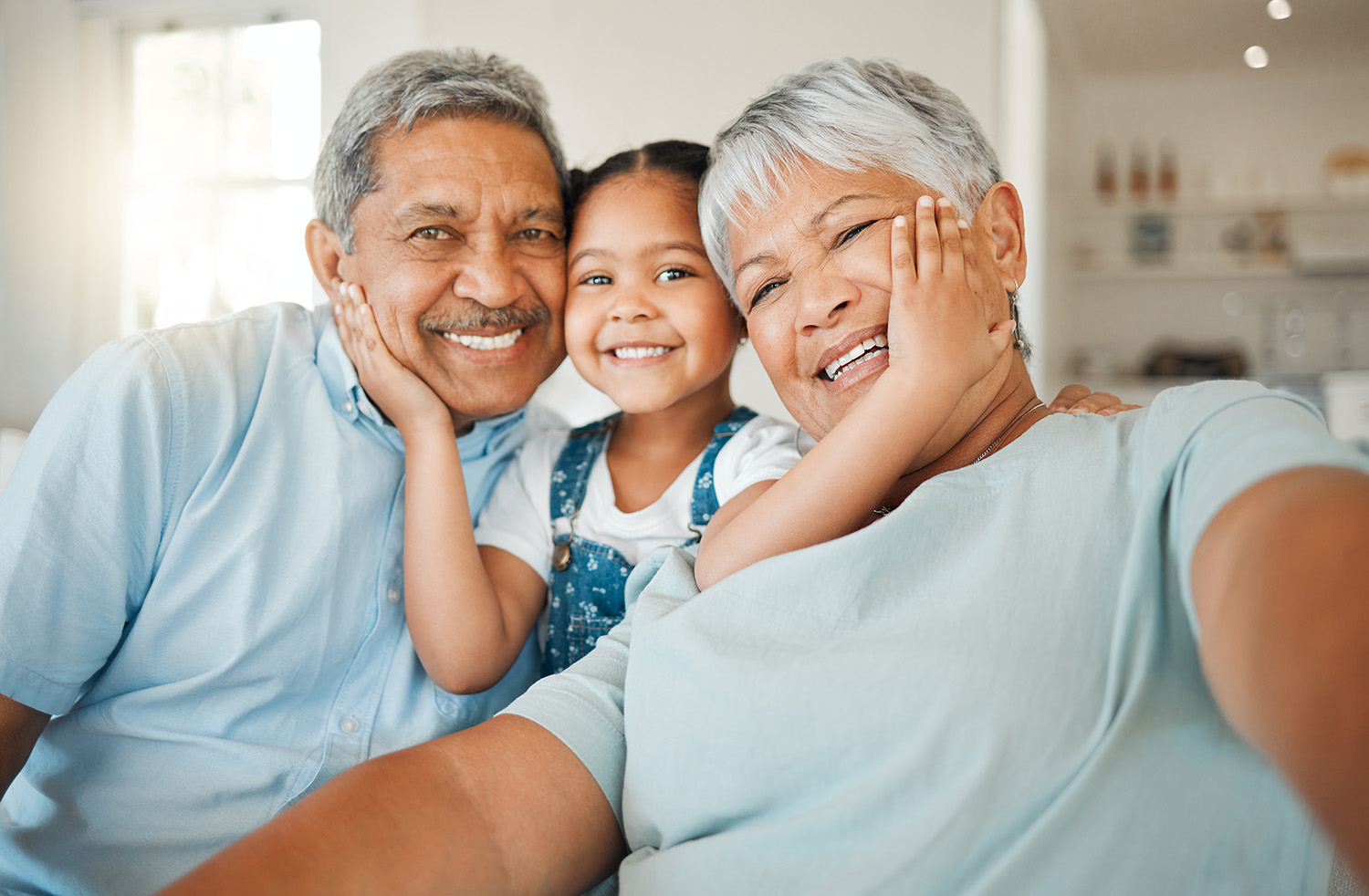 Happy grandparents with granddaughter. 